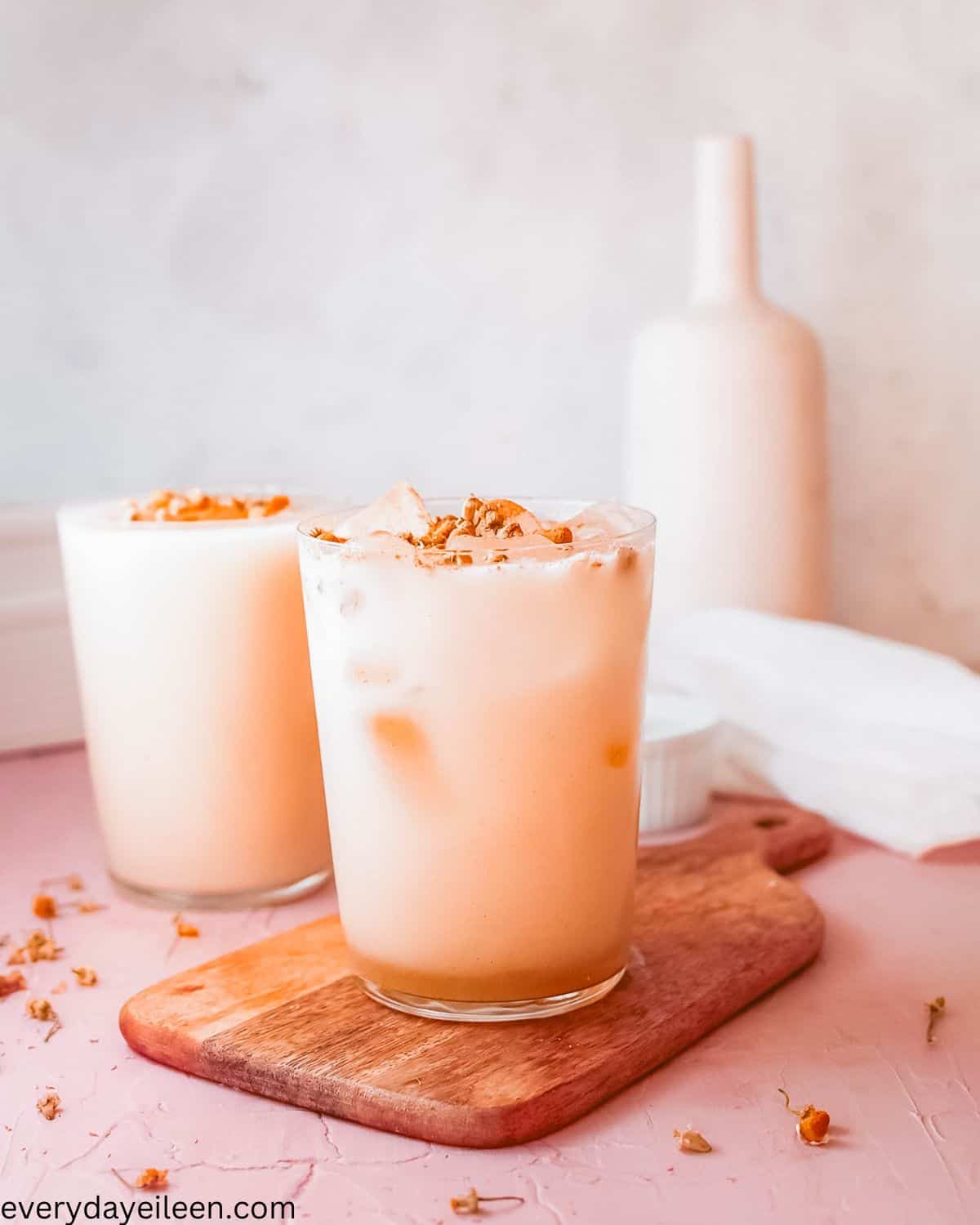 Iced Chamomile Latte made with milk topped with cinnamon in glasses.