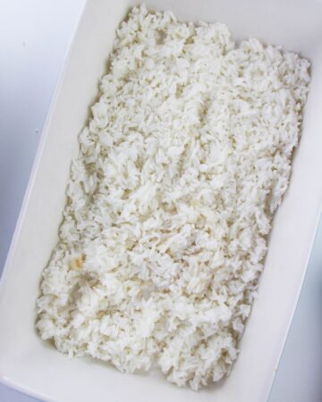 A large casserole dish with white rice in the pan.