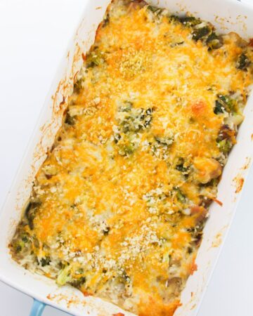 A large casserole of baked broccoli, chicken, and rice topped with melted cheese.