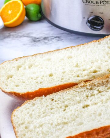 A loaf of Italian bread sliced open and on a table.