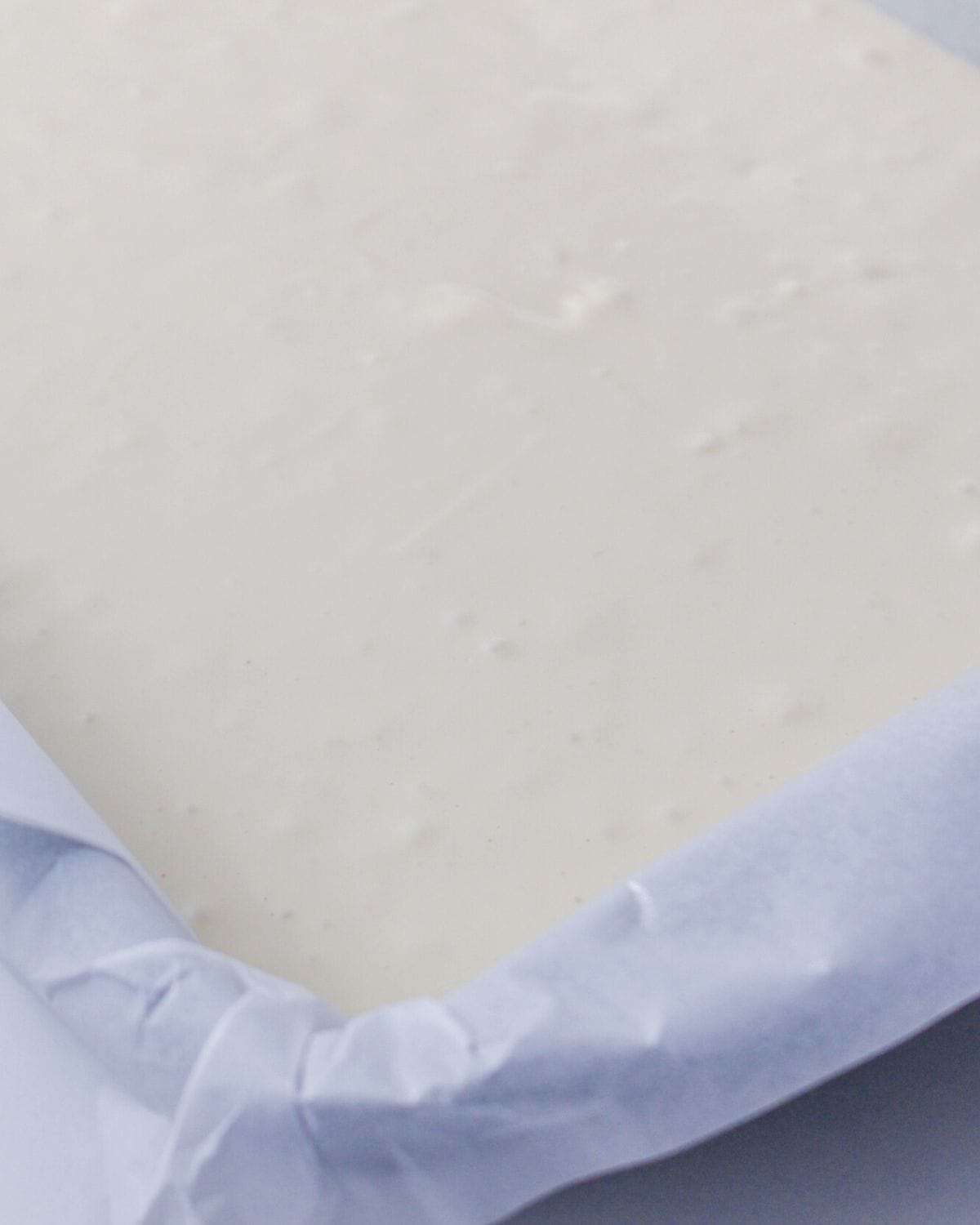 A prepared baking pan filled with pecan cream cheese in the pan.