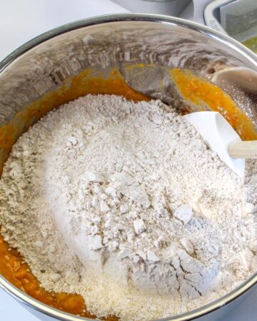 Dry ingredients added to to the pumpkin ingredients to make pumpkin banana bread