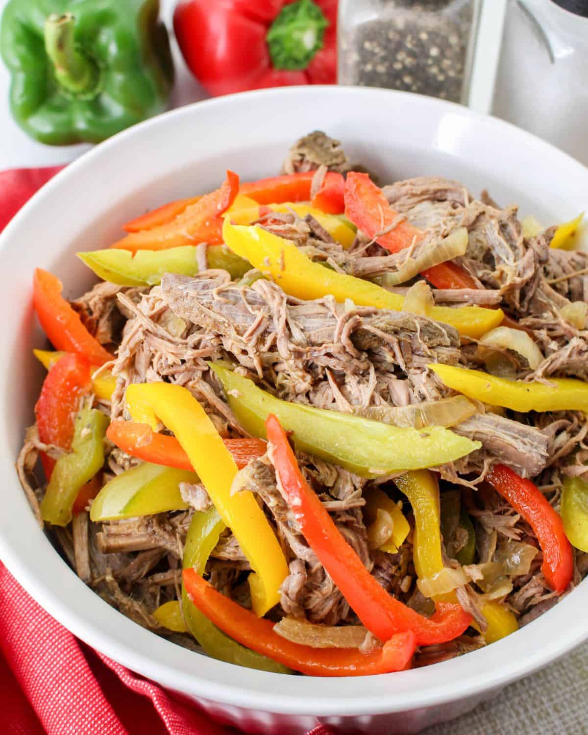 A bowl of shredded beef and peppers made in the slow cooker.