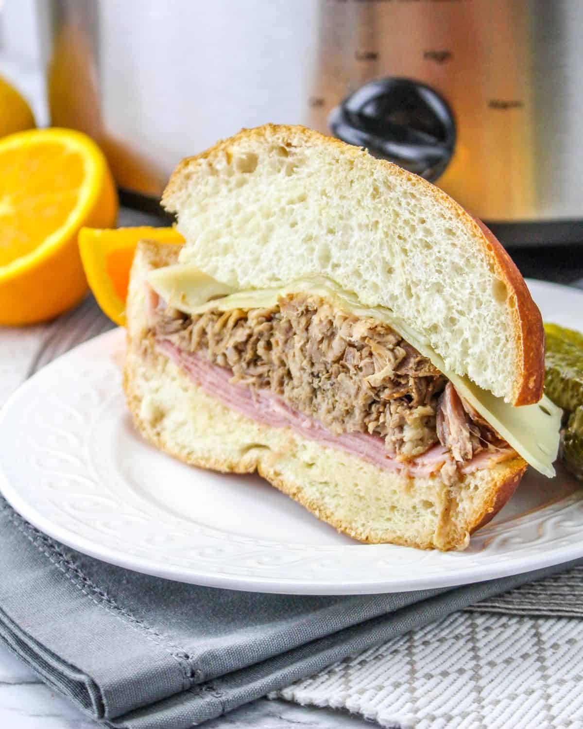 Slow cooker cuban sandwich on a plate.