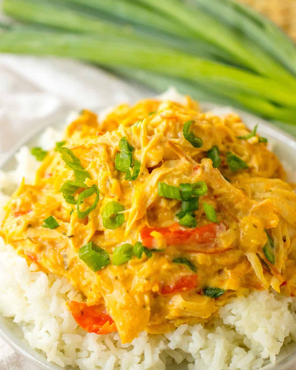 A plate of shredded sweet chili chicken over rice. 