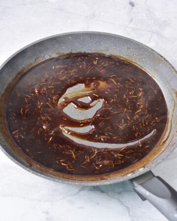 A saute pan with the ingredients to make a stir fry sauce for beef and broccoli stir fry.