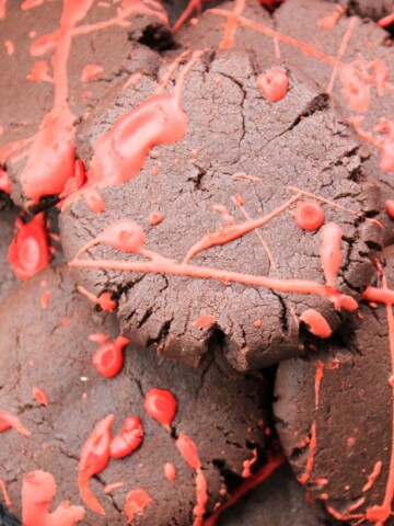 Blood splattered chocolate Halloween cookies on a plate.