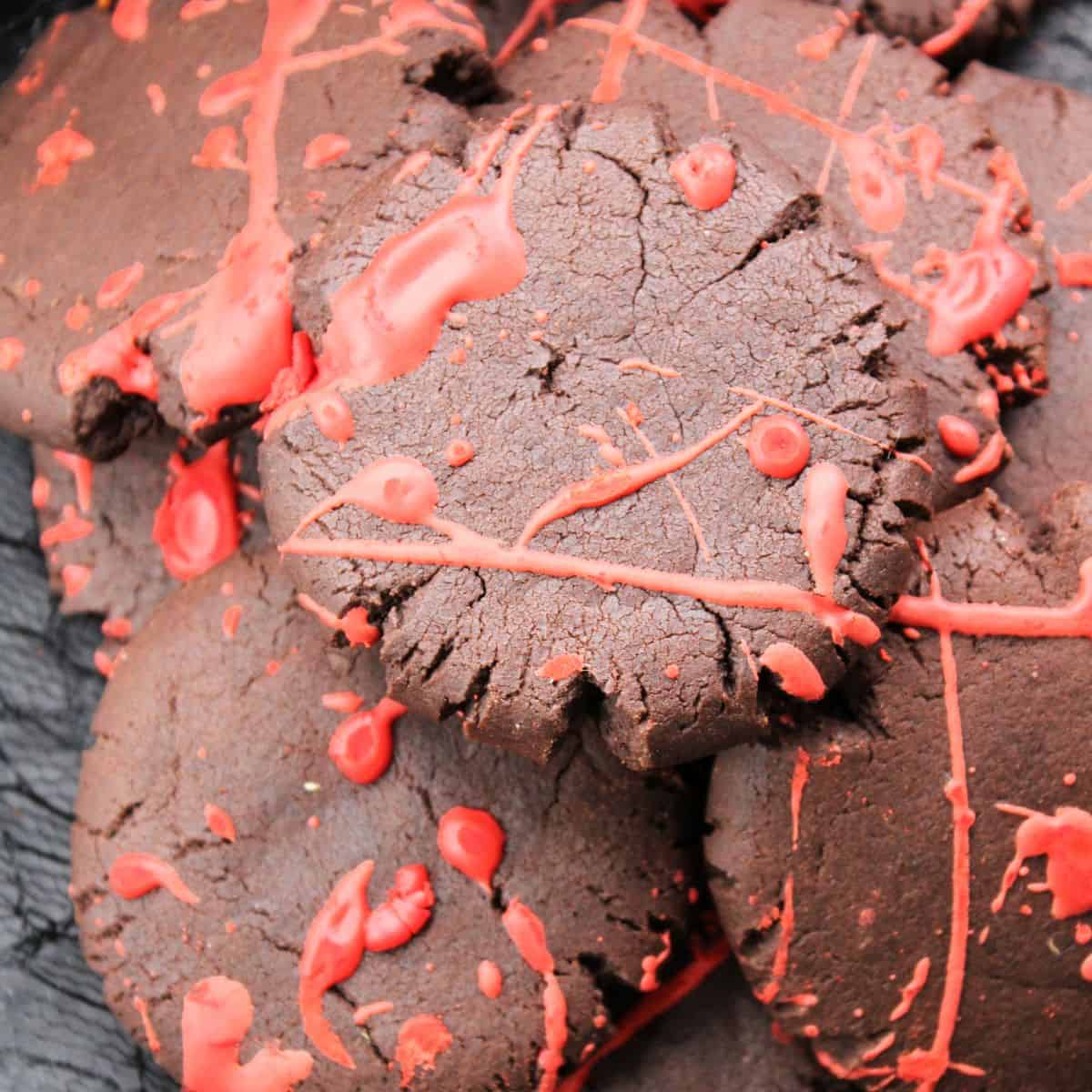 Blood splattered chocolate Halloween cookies on a plate.