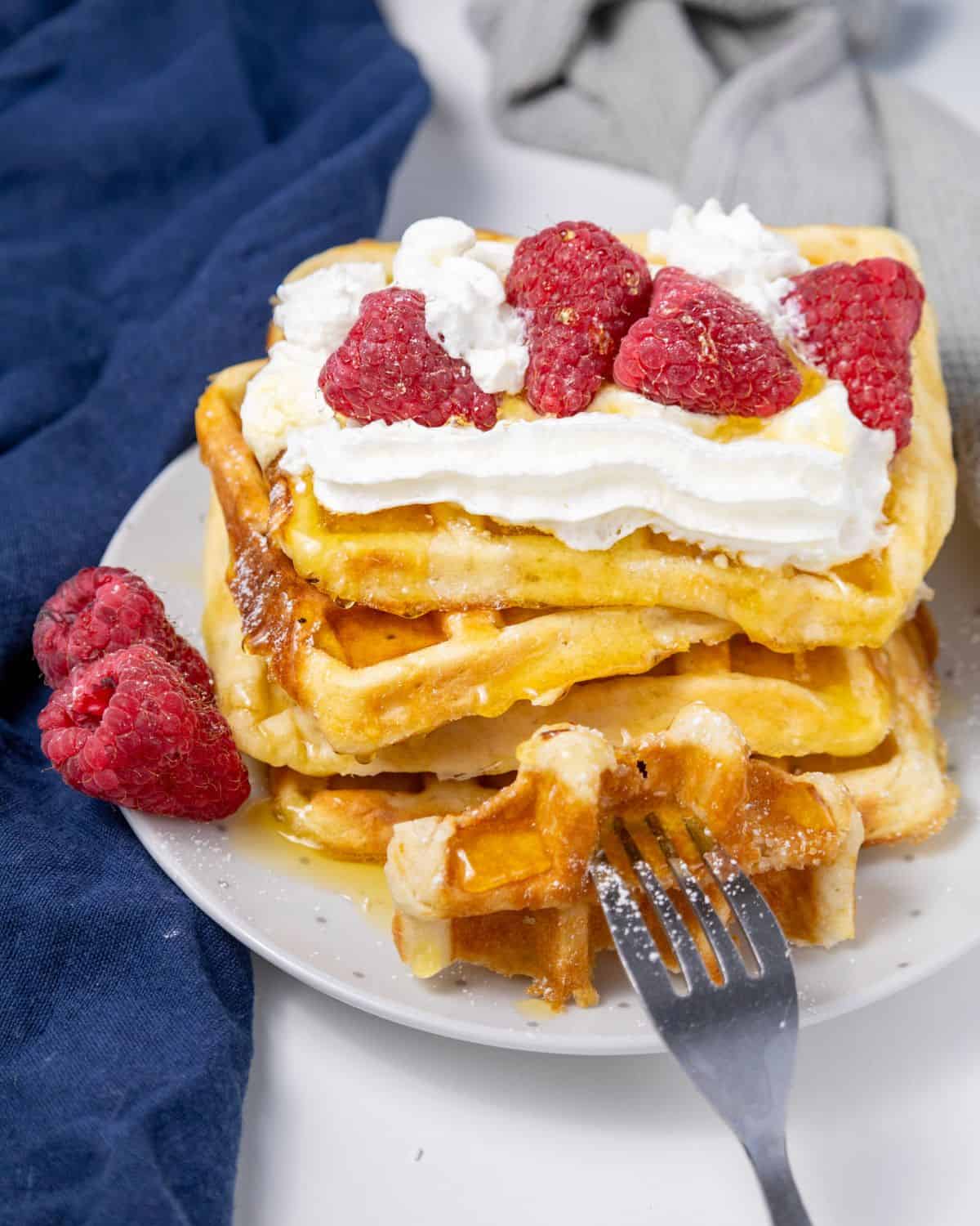 Homemade Eggo Waffle recipe stacked up and topped with syrup. 