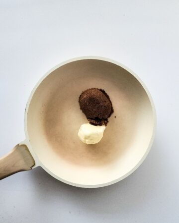 A sauce pan with butter and brown sugar in the pan. 