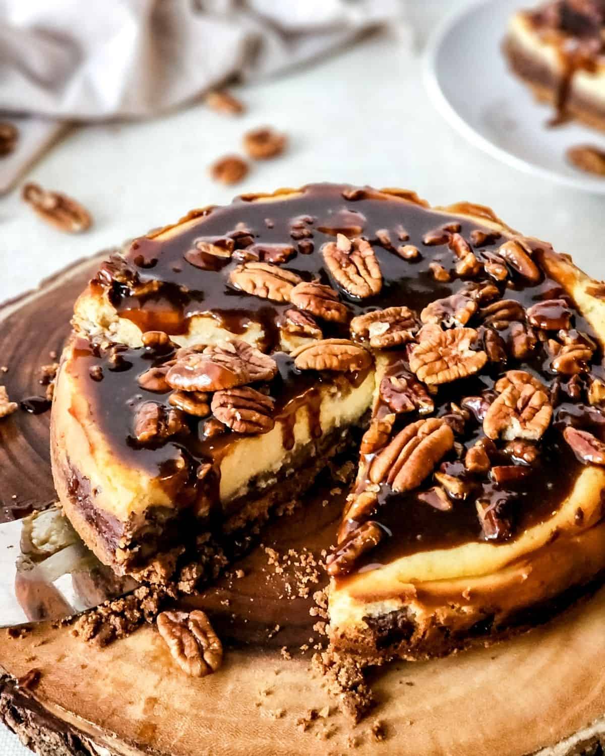 Pecan pie cheesecake with a slice cut out of the pie.