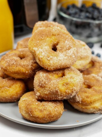 A plate of biscuit donuts made in the air fryer.