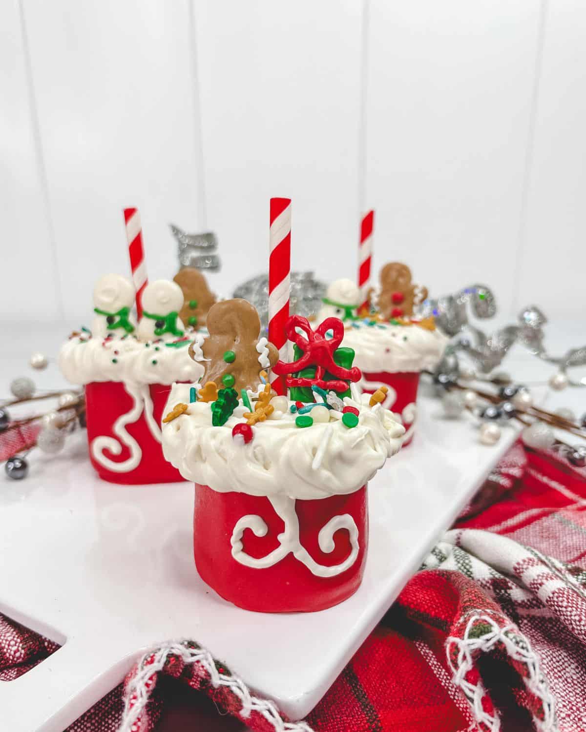 Santa bag marshmallow pops with a white frosting and sprinkles.