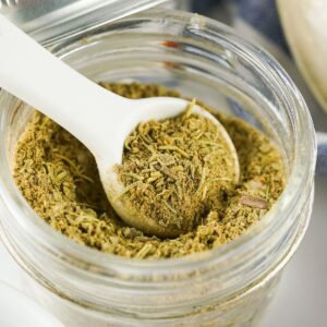 Homemade poultry seasoning in a glass jar.