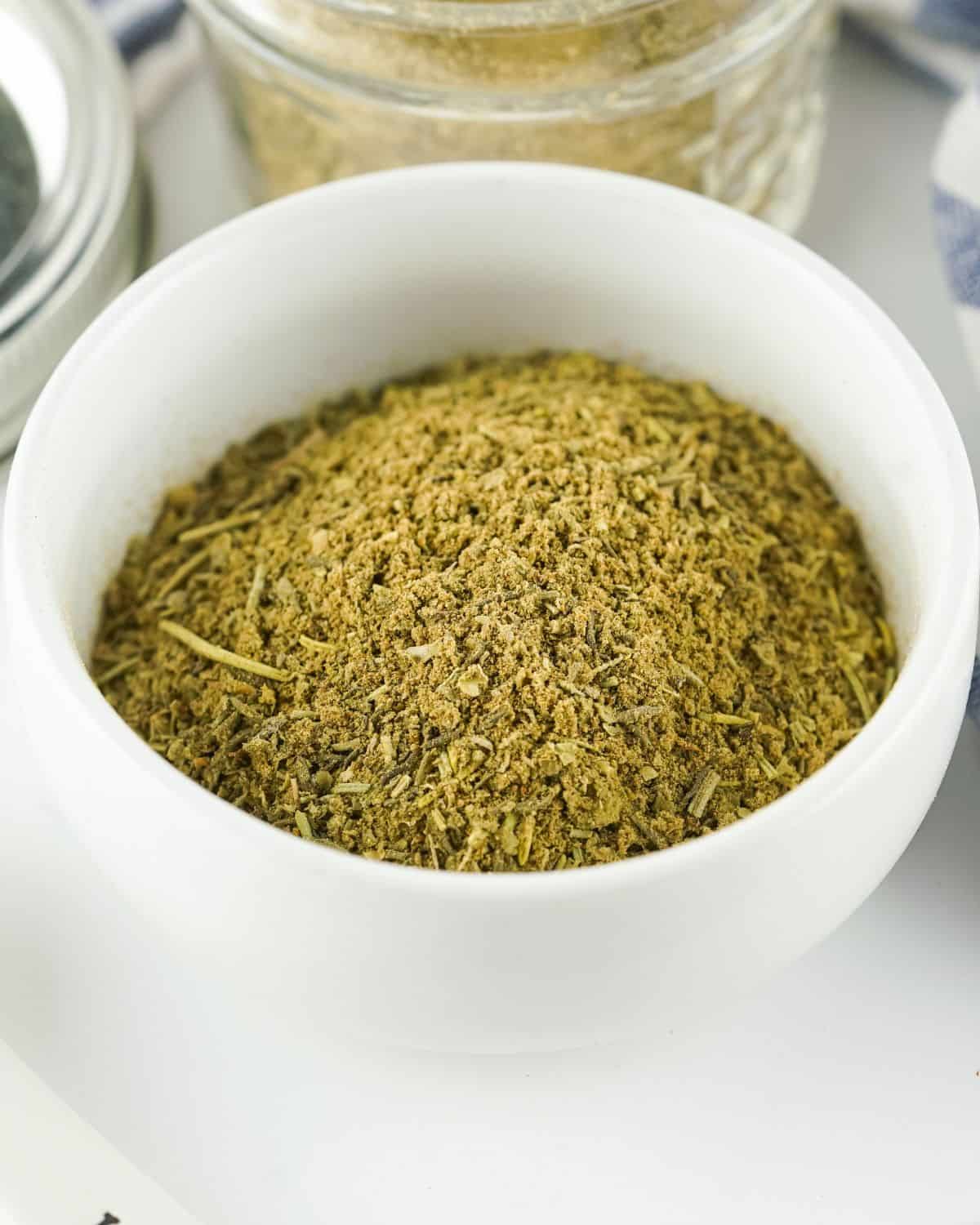 A white bowl with homemade poultry seasoning. 