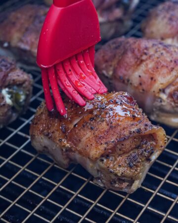 Smoked chicken breasts stuffed with jalapeno popper filling, wrapped with bacon and sprinkled with seasoning. 
