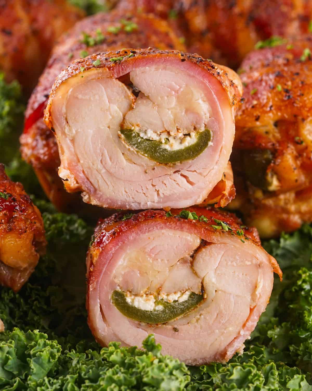 Smoked boneless, skinless chicken thighs wrapped with bacon and filled with jalapenos filled with cream cheese.
