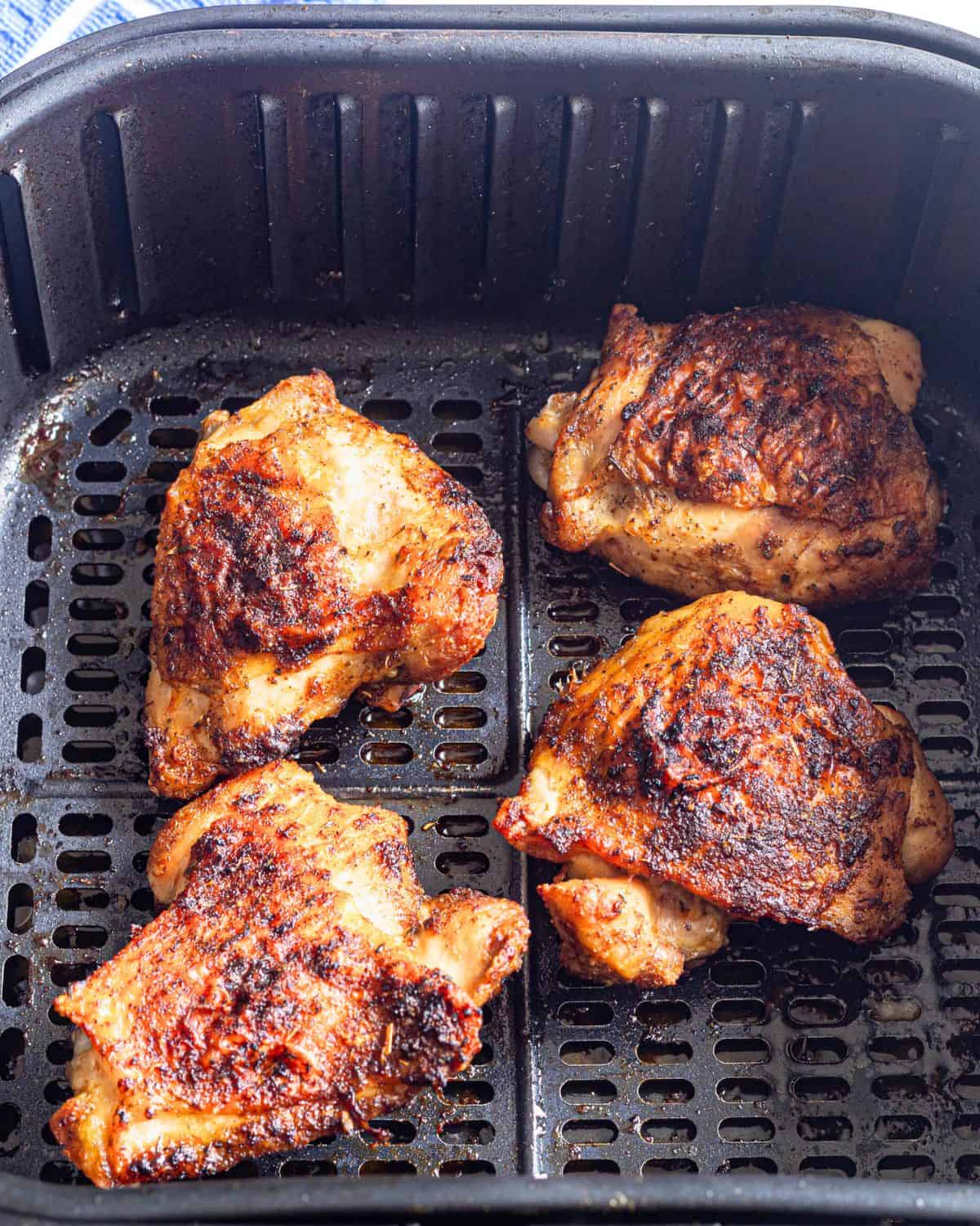 Air fryer chicken thighs cooked in the air fryer with a chicken rub.