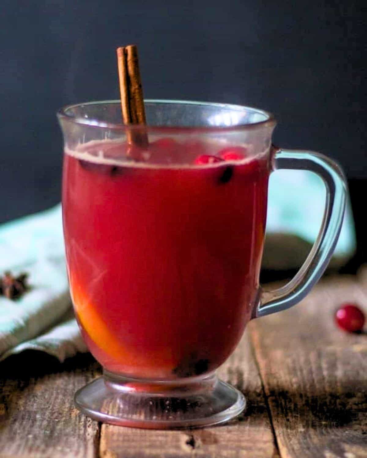 Warm cranberry punch in a glass clear mug.