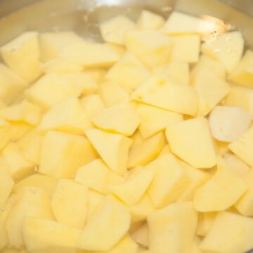 Cubed potatoes in water to make mashed potatoes.