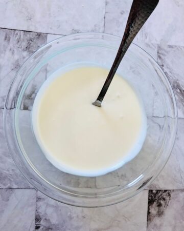 A bowl of white chocolate melted to make white chocolate bark.