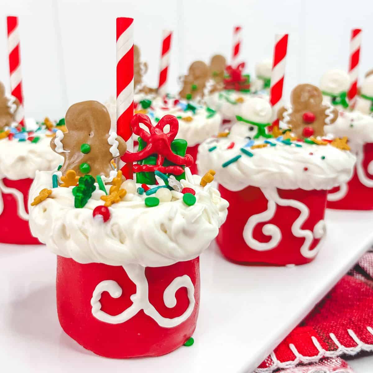 Marshmallow pops made into Santa bags decorated with icing and sprinkles.