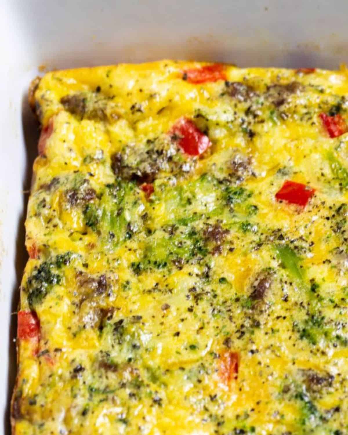 An egg casserole with sausage and veggies in a casserole pan.