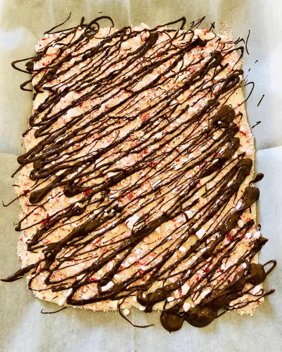 White Chocolate Peppermint Bark drizzled with melted chocolate.