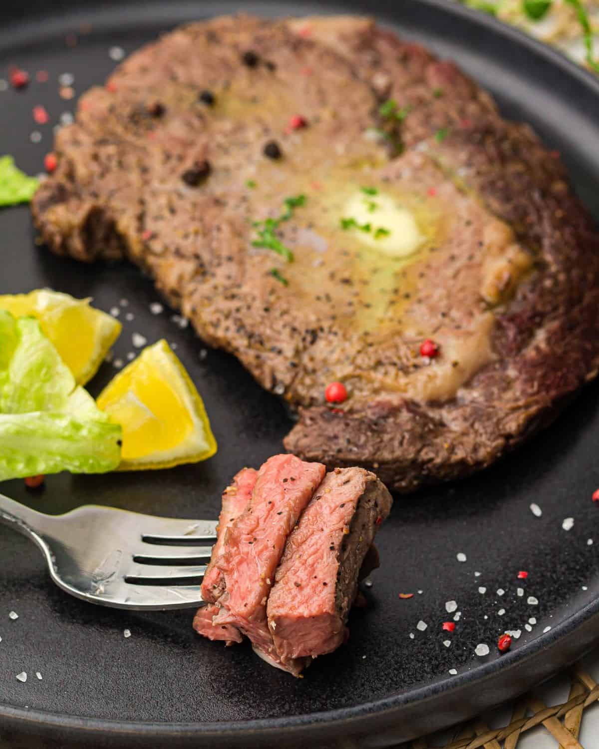 A prime rib steak made in the air fryer on a plate.