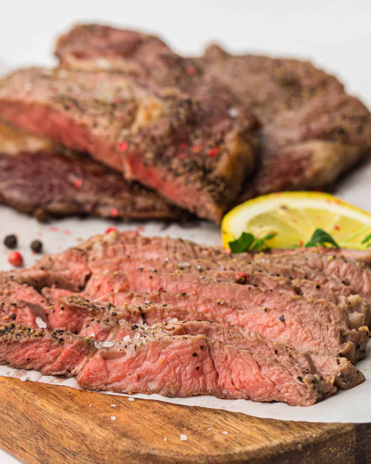 Sliced air fryer rib eye steaks on a plate. 