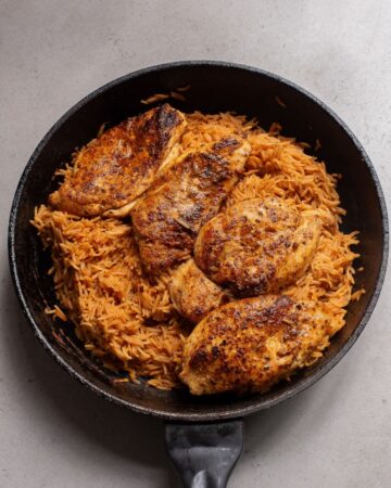 Cajun chicken and rice in a saute pan. 