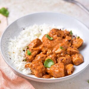 Coconut chicken curry recipe with rice and chopped cilantro.