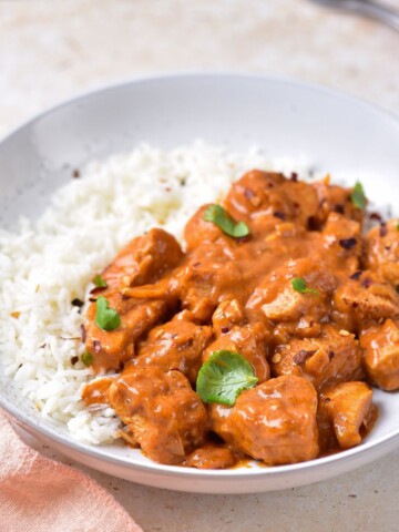 Coconut chicken curry recipe with rice and chopped cilantro.