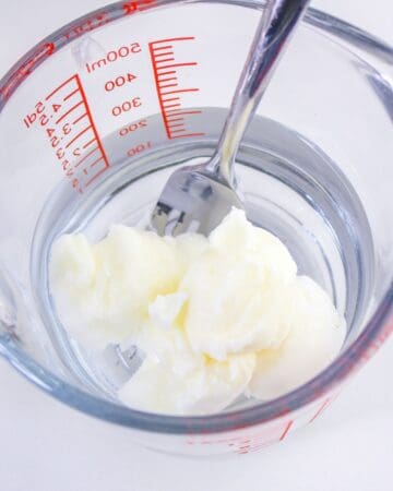 Vegetable oil and water in a mixing bowl.