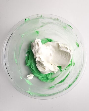 Grasshopper pie being mixed in a glass bowl.