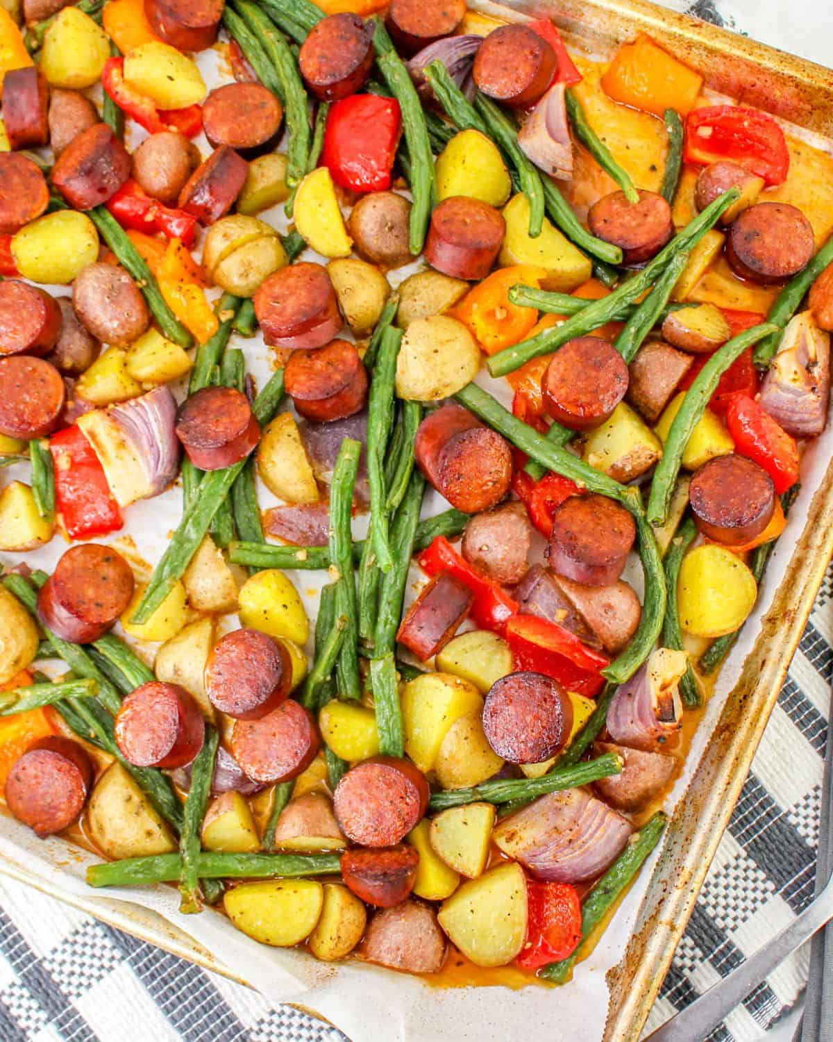 A sausage and potato sheet pan dinner with cajun seasoning.