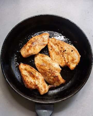 Chicken breasts browned to make chicken fajita pasta.