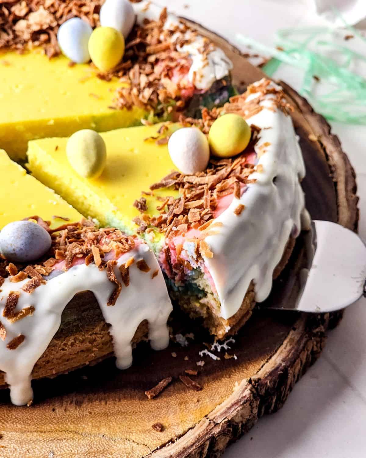 An easter cheesecake with robins eggs on top with white chocolate and coconut.