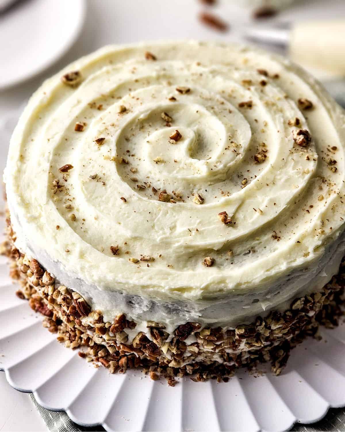 Homemade carrot cake with a cream cheese frosting and pecans.