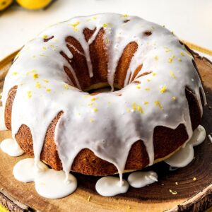 A lemon glazed lemon bundt cake on a platter.