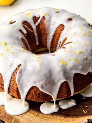 A lemon glazed lemon bundt cake on a platter.