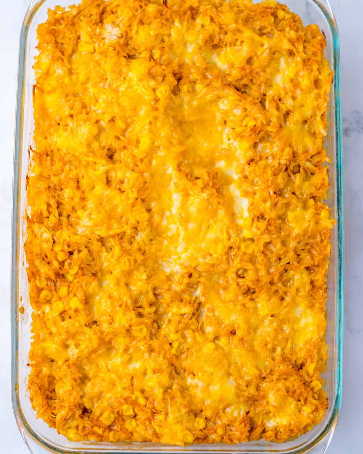 A baked Mexican chicken rice enchilada casserole on a counter.