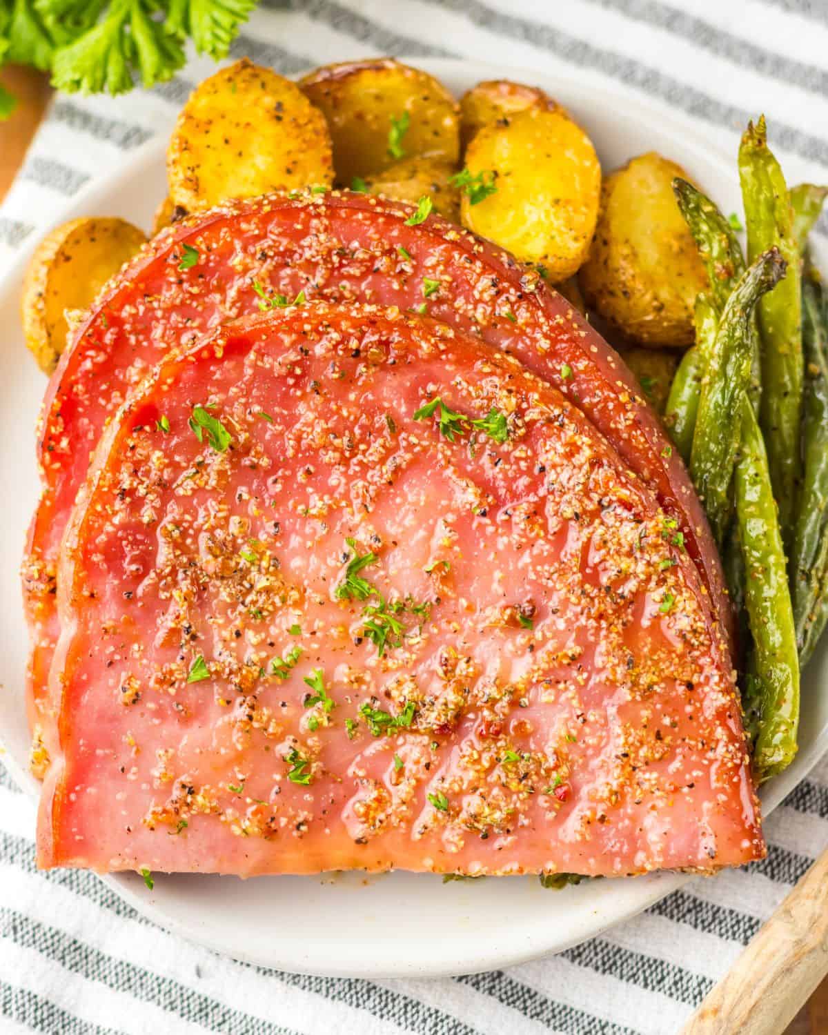 Slice ham, potatoes, and green beans made on a sheet pan. 