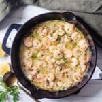 Shrimp Scampi in a cast iron pan with lemon garlic butter sauce.