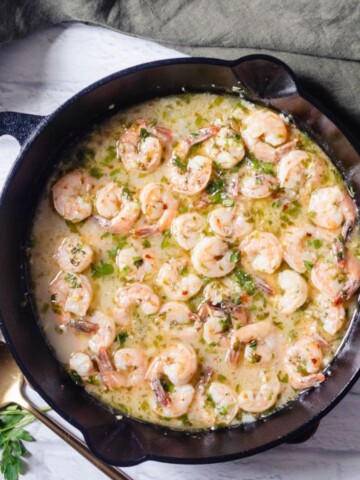 Shrimp Scampi in a cast iron pan with lemon garlic butter sauce.