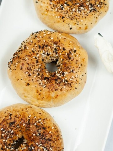 Air fryer bagels with everything seasoning on top of the bagels.