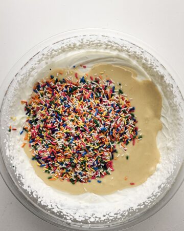 The ice cream mixture with rainbow sprinkles to make a no churn ice cream.