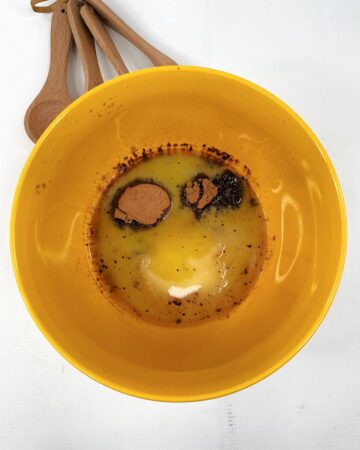 A large mixing bowl with eggs and batter.