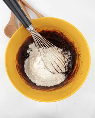A bowl with flour and chocolate to make brownies.