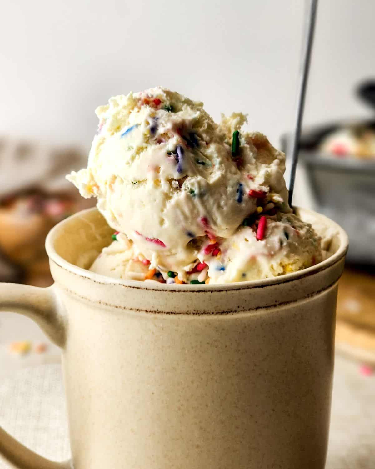 No Churn Birthday Cake Ice Cream scooped into a cup. 